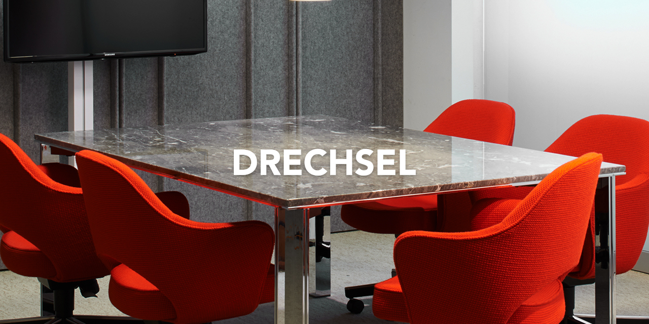 Conference room with burnt orange chairs and Drechsel Logo overlayed on top of it